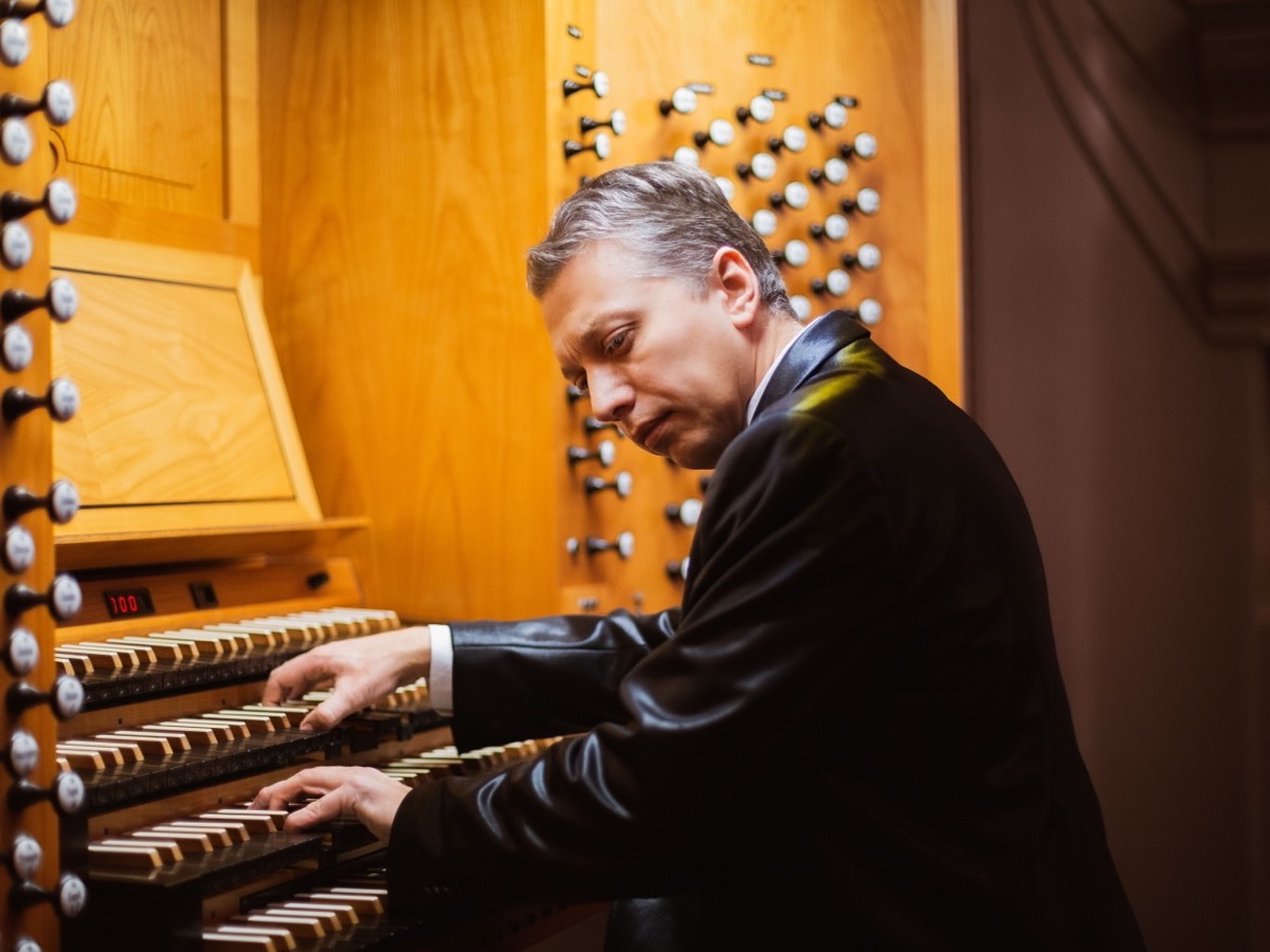 An organist playing at a church organ console